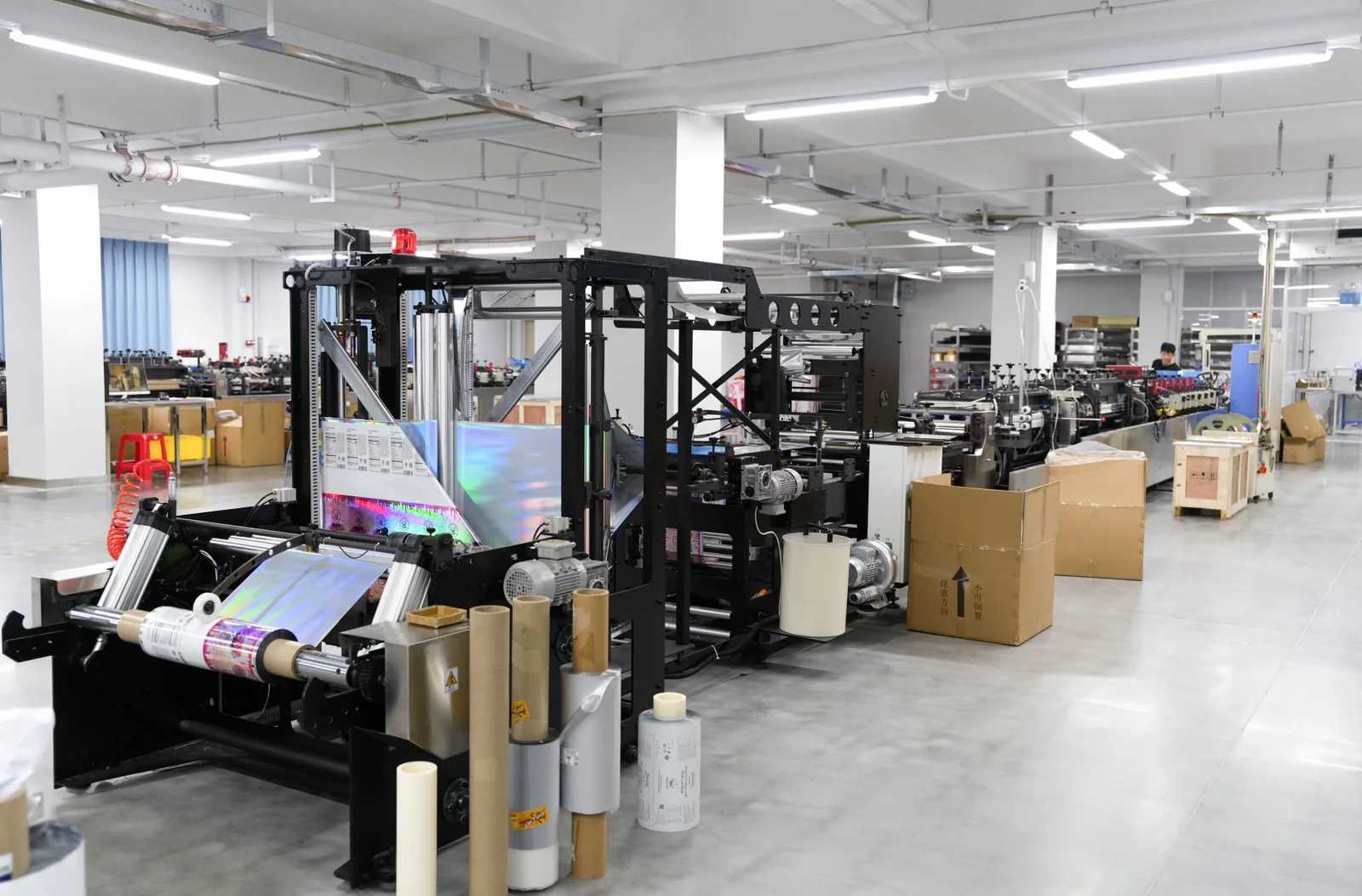 Operator running flexible packaging production equipment