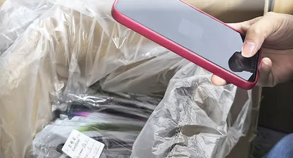 Approved packaging sample being checked against project reference